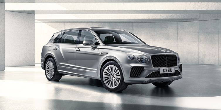 Bentley Mougins Bentley Bentayga Extended Wheelbase SUV front three quarter in Moonbeam paint with a grey background