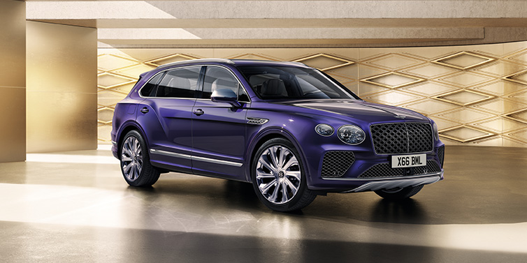 Bentley Mougins Bentley Bentayga Extended Wheelbase Mulliner SUV front three quarter in Tanzanite Purple paint with a gold patterned background