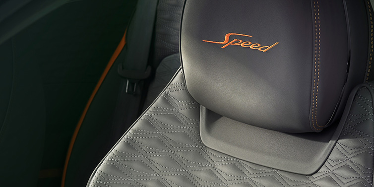 Bentley Mougins Bentley Continental GT Speed coupe seat detail in Gravity Grey hide and Speed emblem in Mandarin by Mulliner coloured embroidery