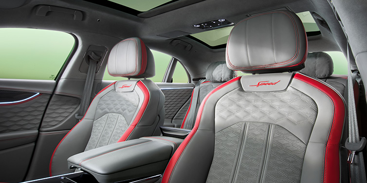 Bentley Mougins Bentley Flying Spur Speed sedan interior showing front and rear seats in Hotspur red and Gravity Grey hides, with Speed seat emblems