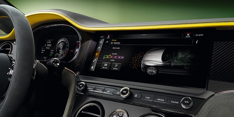 Bentley Mougins Bentley Continental GTC Speed convertible front interior centre console with MMI screen showing Air Quality visualisation surrounded by Cyber Yellow by Mulliner and Gravity Grey hides and high gloss carbon fibre veneer