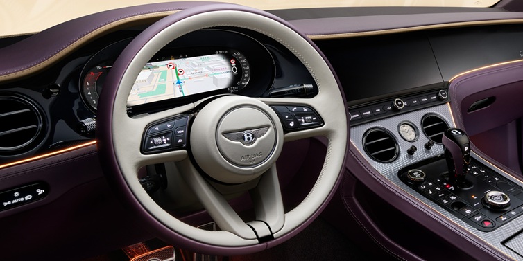 Bentley Mougins Bentley Continental GT Mulliner coupe front interior showing steering wheel and drivers screens surrounded by Linen and Damson hides and Grand Black veneer