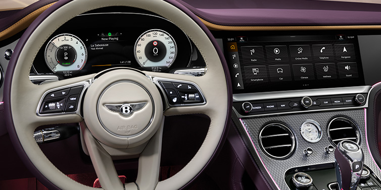 Bentley Mougins Bentley Continental GTC Mulliner convertible steering wheel and drivers screens surrounded by Damson purple and Linen hides